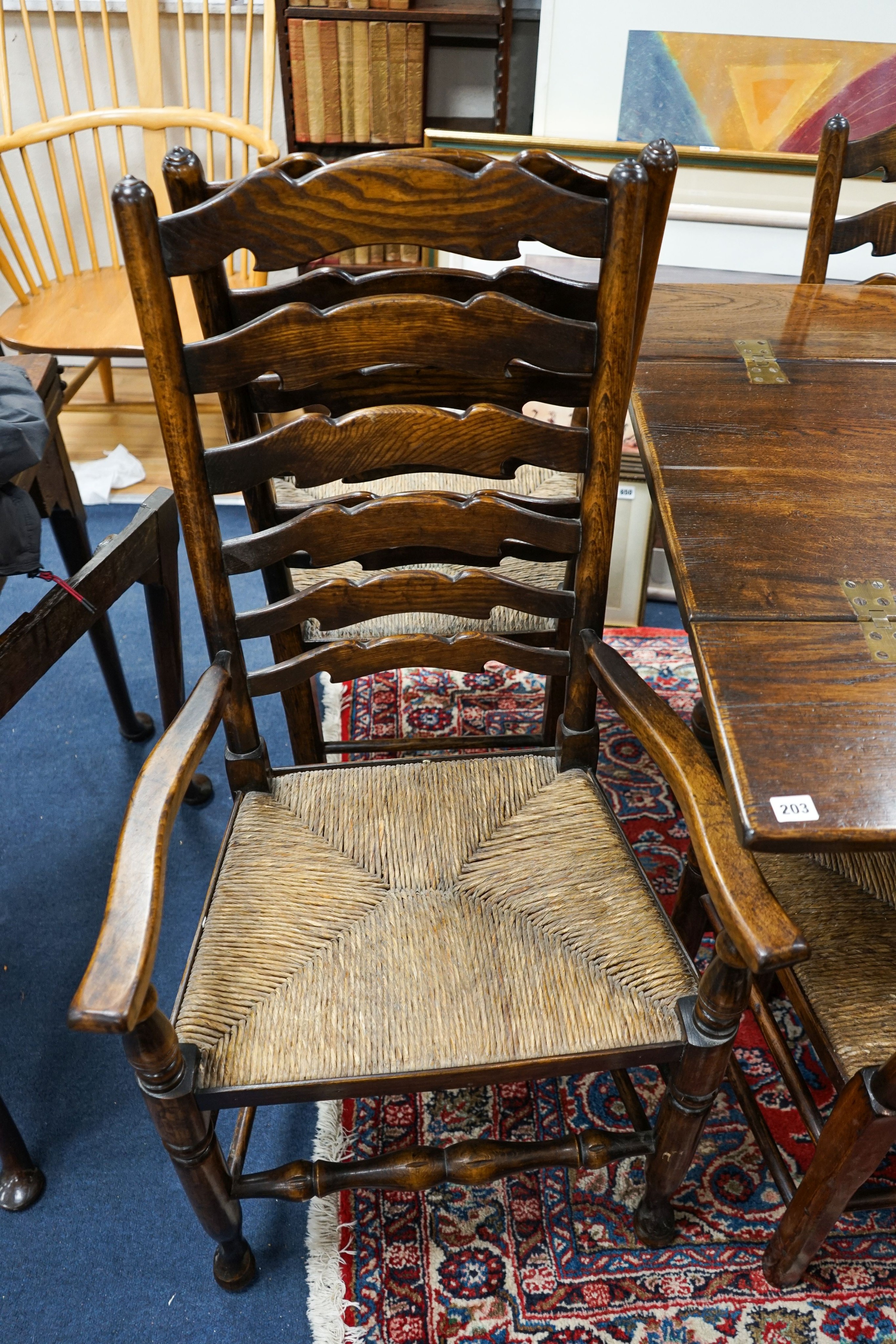 A set of eight Titchmarsh & Godwin elm and beech ladderback rush seat chairs, two with arms